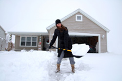shoveling snow at house