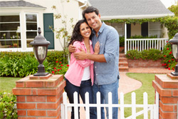 couple in front of house