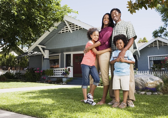 family in front of house